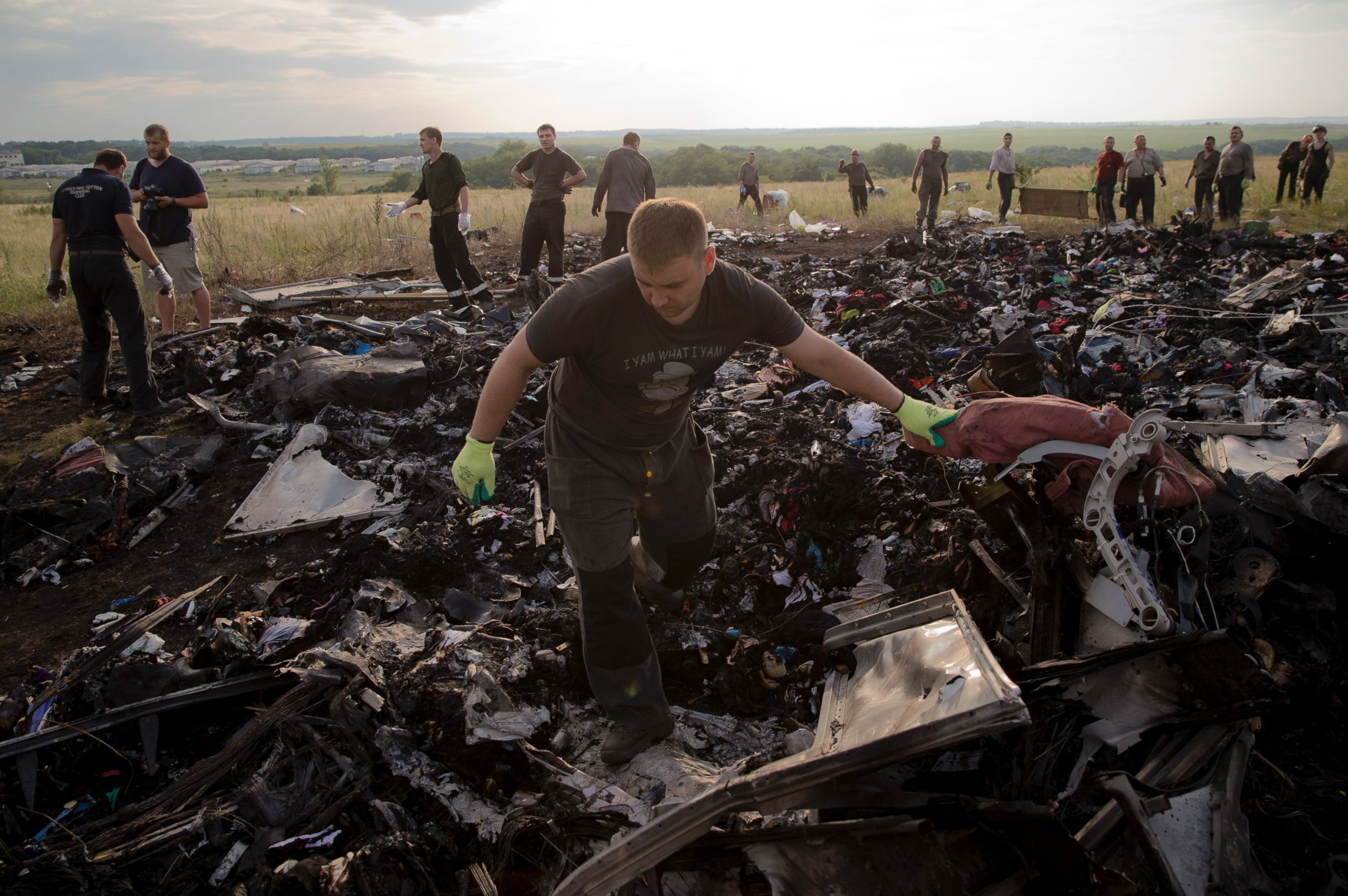 PHOTO: A man looks for the remains of victims in the debris at the crash site of Malaysia Airlines Flight 17 near the village of Hrabove, eastern Ukraine, July 19, 2014.  
