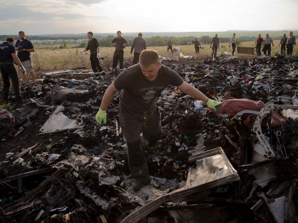 PHOTO: A man looks for the remains of victims in the debris at the crash site of Malaysia Airlines Flight 17 near the village of Hrabove, eastern Ukraine, July 19, 2014.