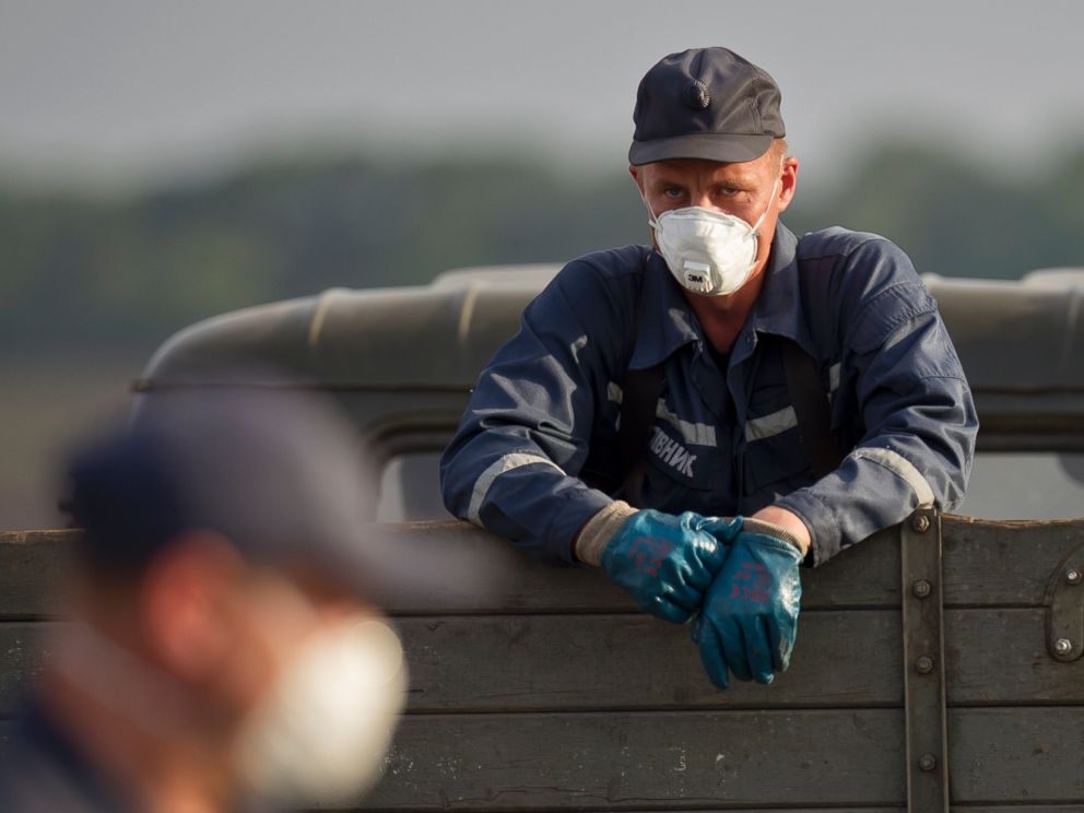 PHOTO: An emergency worker pauses in a truck loaded with bodies of the victims at the crash site of Malaysia Airlines Flight 17 near the village of Hrabove, eastern Ukraine, July 19, 2014.