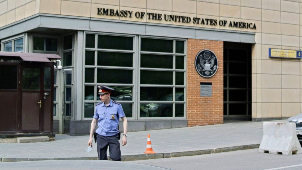 In this file photo, a Russian police officer stands in front of an entrance of the U.S. Embassy in Moscow, May 14, 2013.