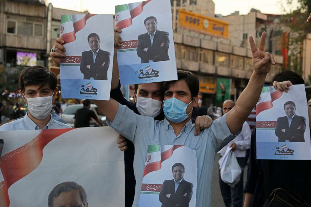 PHOTO: Supporters of Abdolnasser Hemmati, a presidential candidate in the June 18, elections, hold signs with his picture, during a street rally in Tehran, Iran, Tuesday, June 15, 2021. 