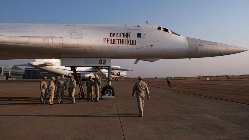 PHOTO: Military personnel gather under a Russian Air Force Tupolev Tu-160 "Blackjack" is parked on the tarmac at the Waterkloof Air force Base in Centurion, south of Pretoria, northeastern South Africa, on Oct. 23, 2019.