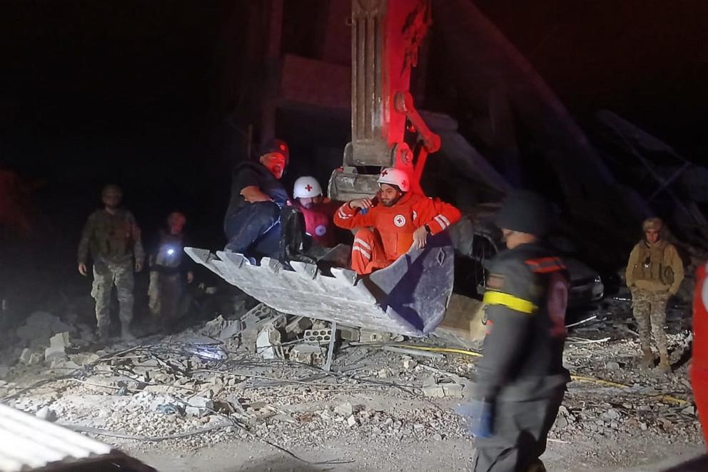PHOTO: This Lebanese Civil Defense photo shows rescue workers on a excavator carrying the body of the Lebanese journalist Amal Khalil, in al-Tiri village, south Lebanon, on April 22, 2026.