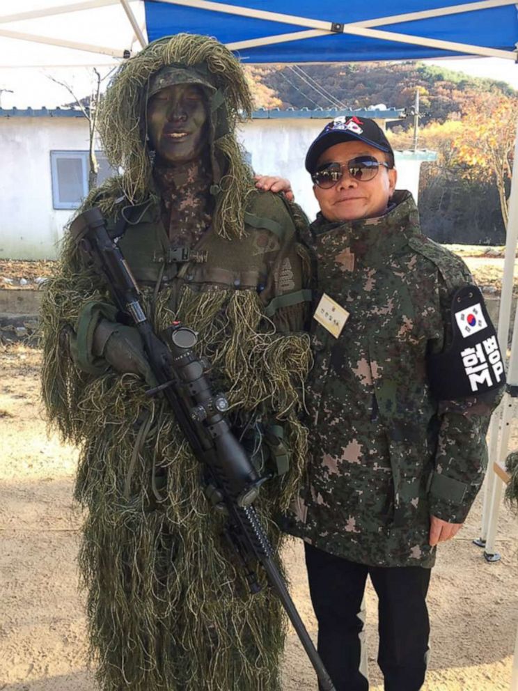 PHOTO: An Chan-il, 66, is a North Korea studies expert in Seoul who defected to South Korea through the demilitarized zone in 1979. He took a photo with a South Korean army soldier during a field trip to the border security area in Cherwon, South Korea. 