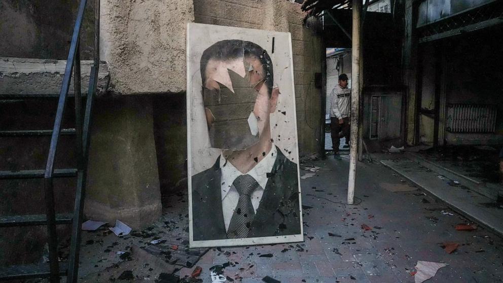 PHOTO: A defaced portrait of ousted Syrian President Bashar Assad stands in a ransacked government security facility in Damascus, Syria, on Dec. 8, 2024.