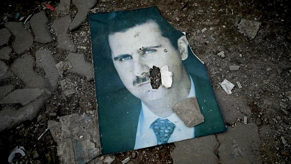 PHOTO: A damaged portrait of Syria's ousted president Bashar Assad lies on the ground in the western Syrian port city of Latakia on Dec. 15, 2024.