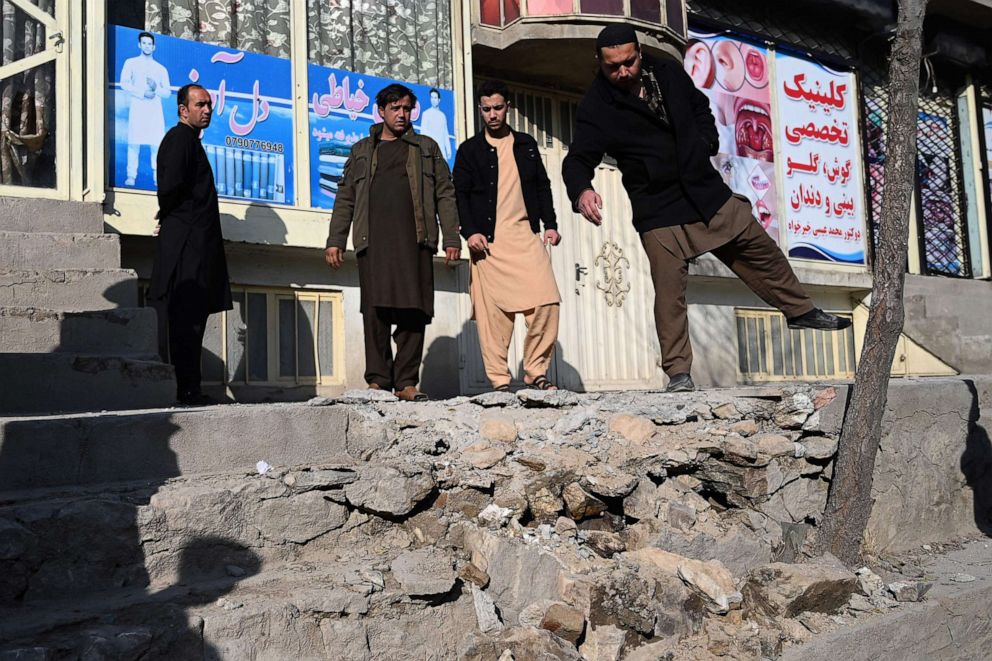 PHOTO: Residents gather at a site after several rockets land at Khair Khana, north west of Kabul on November 21, 2020. 
