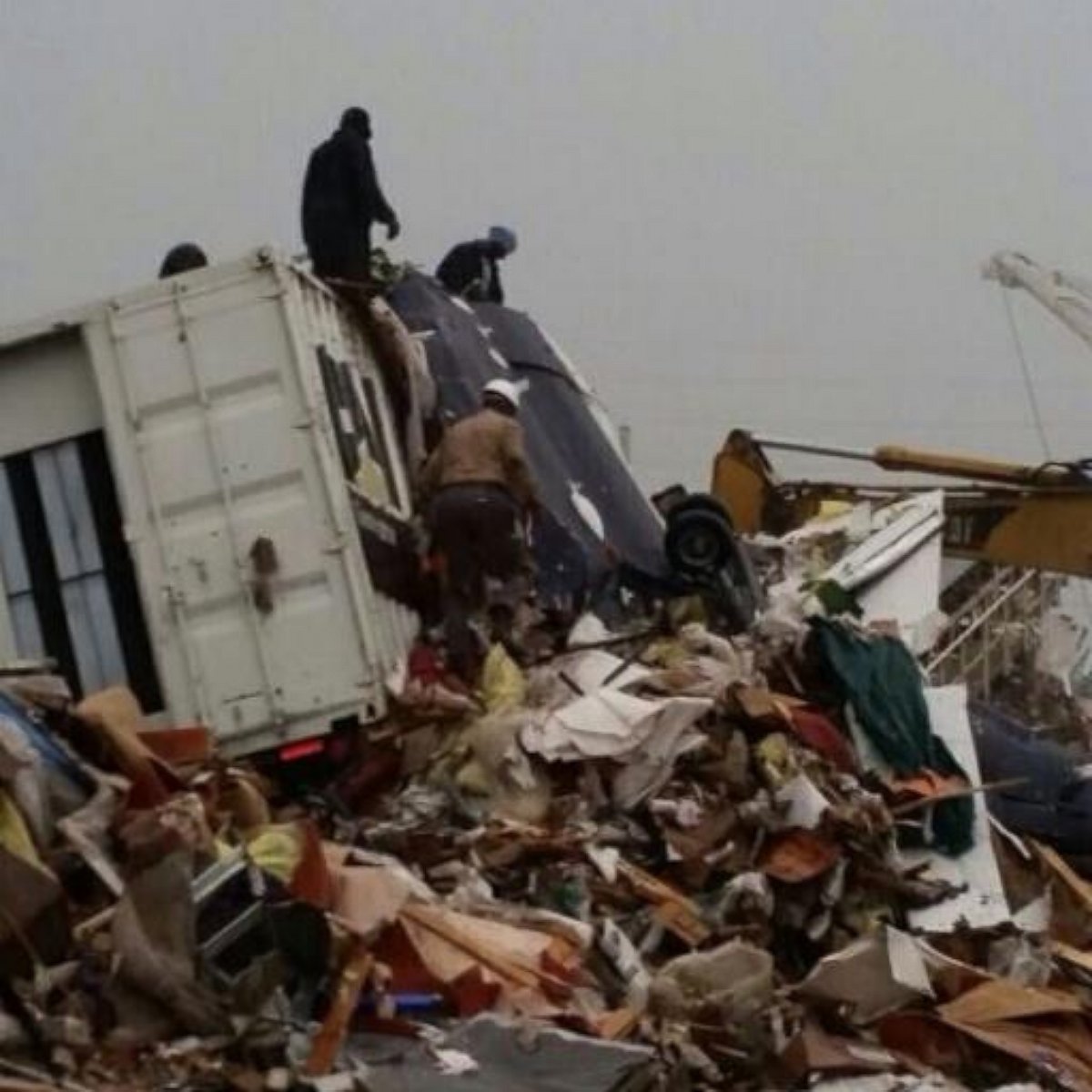 People inspect the wreckage following a jet crash near Grand Bahama International Airport in Freeport, Bahamas, Nov. 9, 2014.