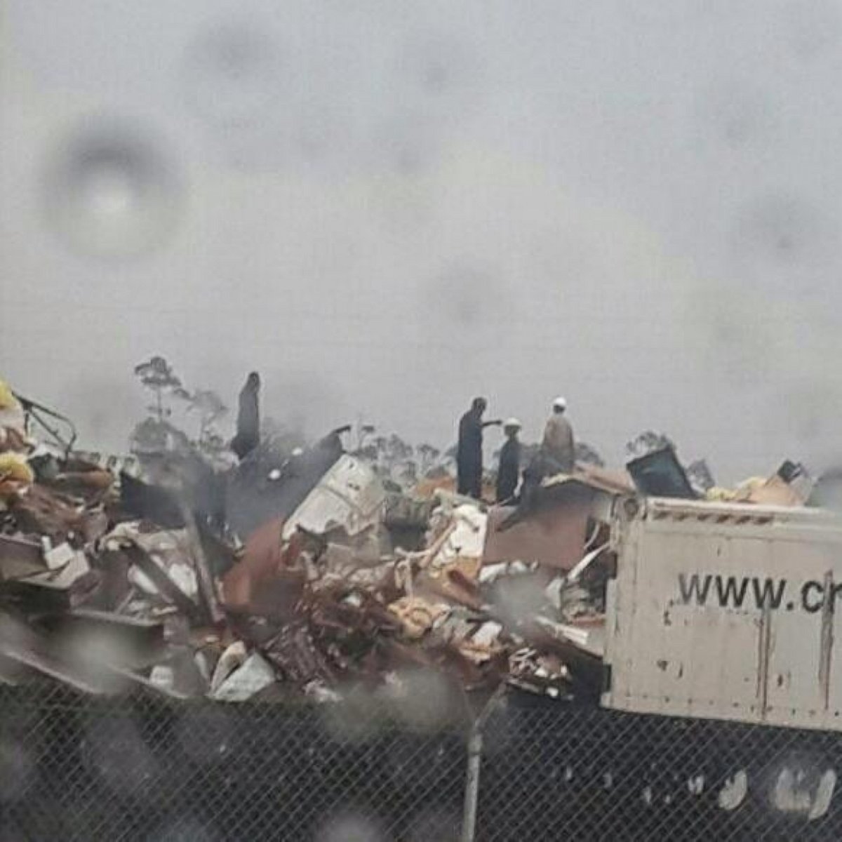 People inspect the wreckage following a jet crash near Grand Bahama International Airport in Freeport, Bahamas, Nov. 9, 2014.