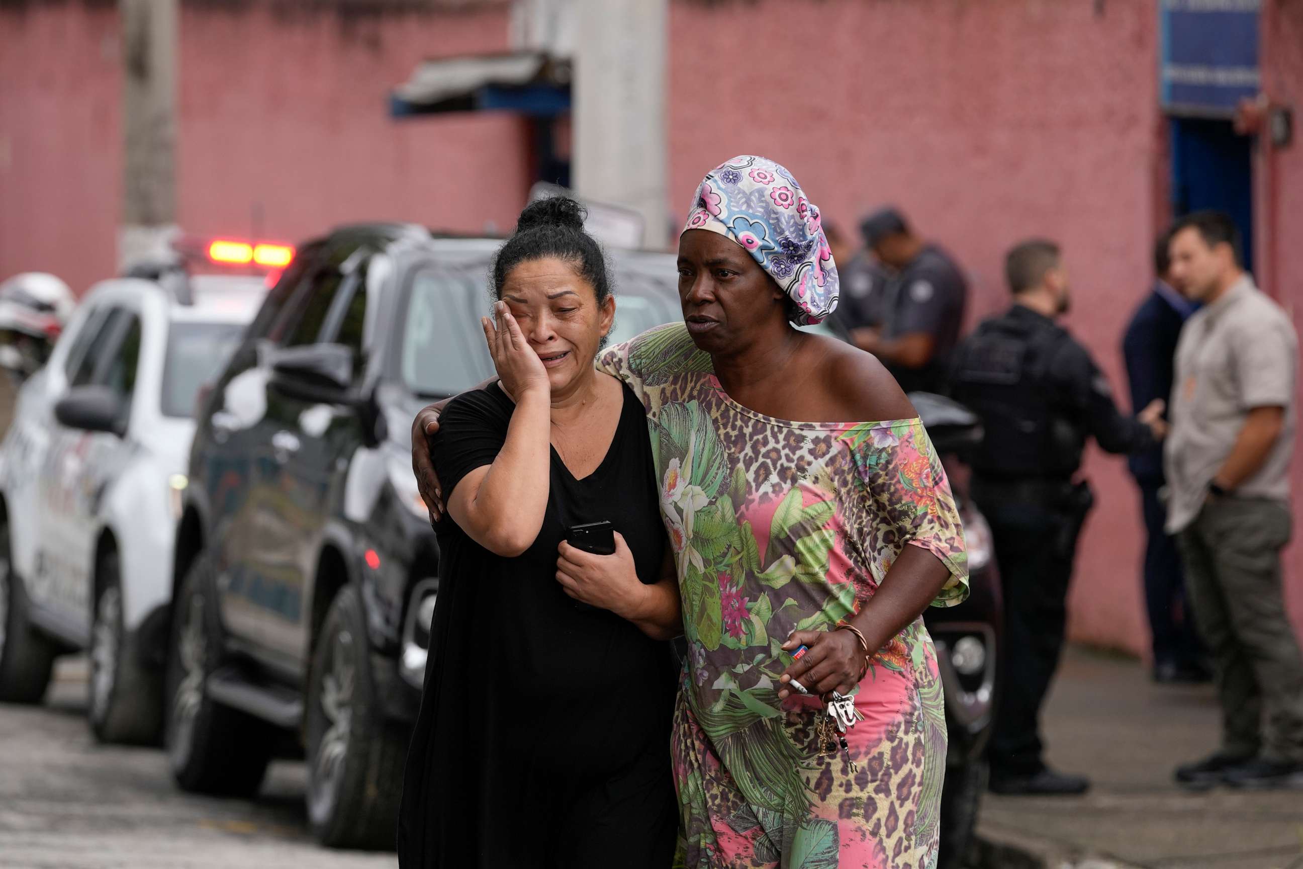 PHOTO: Silvia Palmieri, who is the mother of a teacher who survived a stabbing attack at the Thomazia Montoro school, left, leaves the school comforted by a friend in Sao Paulo, Brazil, March 27, 2023.