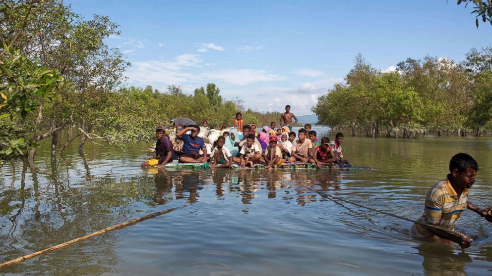 PHOTO: Rohingya Muslims travel on a raft made with plastic containers on which they crossed over the Naf river from Myanmar into Bangladesh, near Shah Porir Dwip, Bangladesh, Nov. 11, 2017. U.N. 