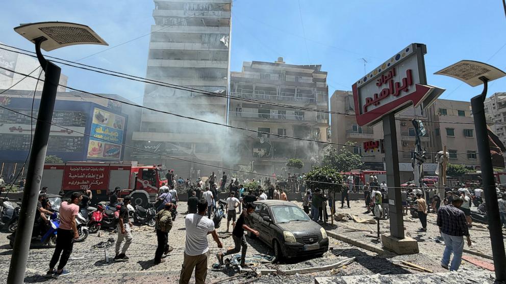 PHOTO: People gather at the site of an Israeli airstrike that targeted a building in Beirut's southern suburbs on June 14, 2026.
