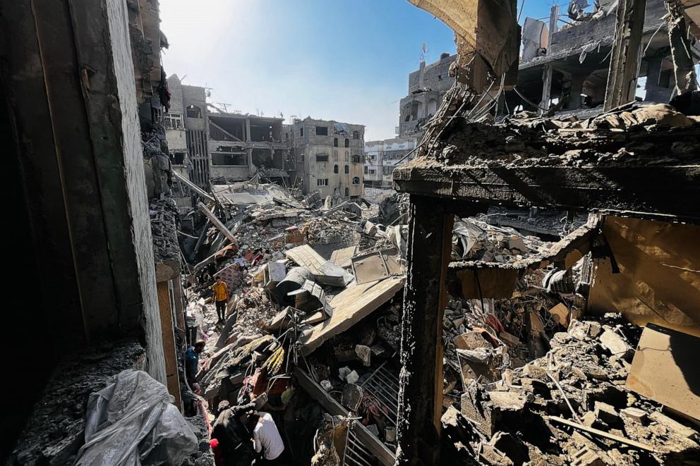 PHOTO: Palestinians search throught the rubble of a building after an Israeli strike in Beit Lahia, in the northern Gaza Strip, on Oct. 29, 2024.