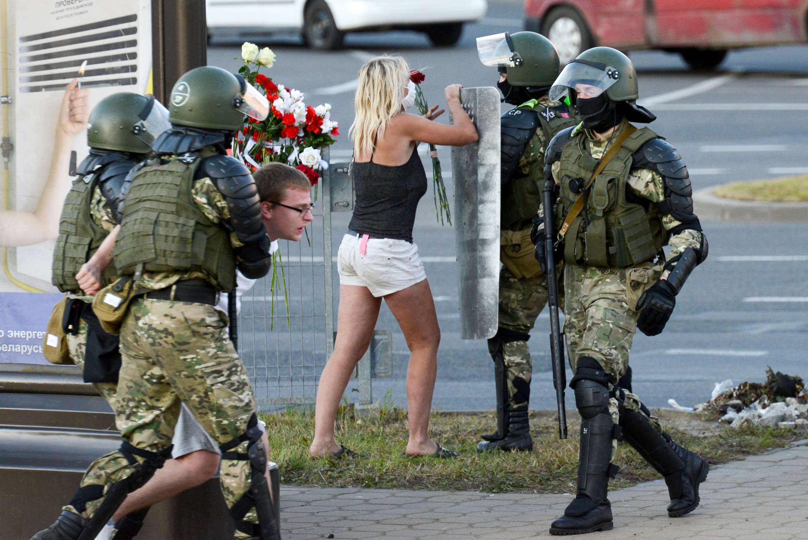 PHOTO: A woman fights with a police officer as the other police officers detain an opposition supporter protesting the election results as protesters encounter aggressive police tactics in the capital of Minsk, Belarus, Tuesday, Aug. 11, 2020. 