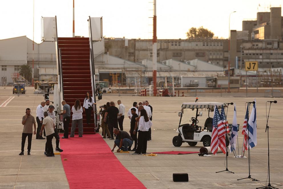 PHOTO: Israeli airport staff prepare the Red Carpet ahead of US President Donald Trump's arrival at Ben Gurion Airport on the outskirts of Lod near Tel Aviv on October 13, 2025.