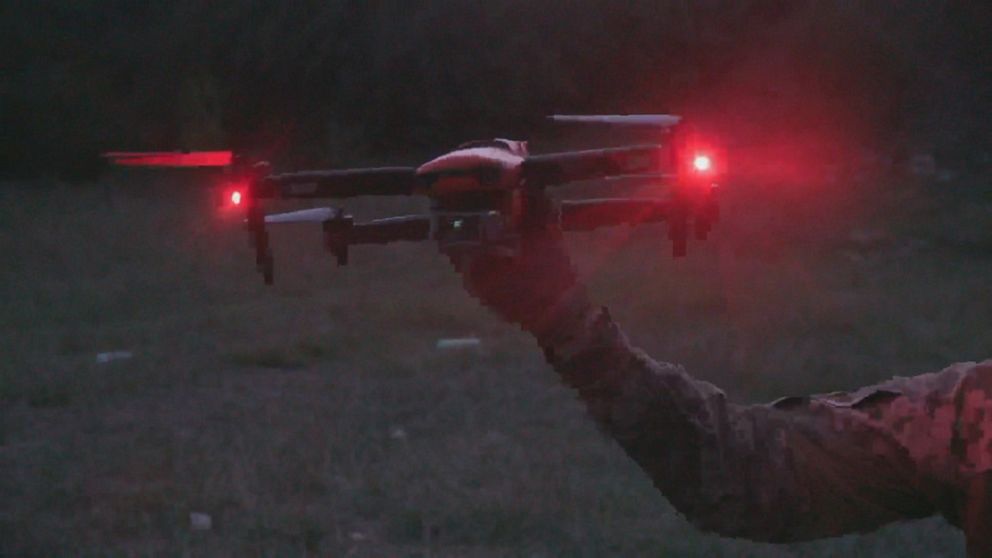 PHOTO: Red lights shine as a drone is held by a member of Ukraine's military, which is using the tech to aid in its counteroffensive. 