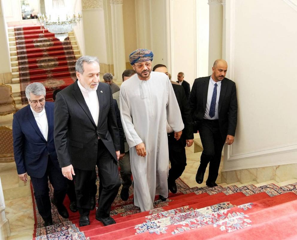 PHOTO: A handout picture provided by the Iranian Foreign Ministry shows Iranian Foreign Minister Abbas Araghchi (C-L) and Oman's Foreign Minister Sayyid Badr al-Busaidi (C-R) walking up stairs for a meeting in Tehran on Aug. 25, 2026.
