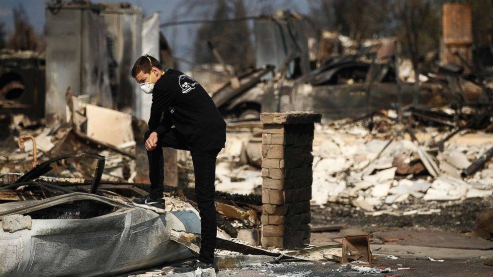 PHOTO: Benjamin Lasker, 16, looks at what remains of his home after a wildfire swept through on Oct. 15, 2017, in Santa Rosa, Calif. 