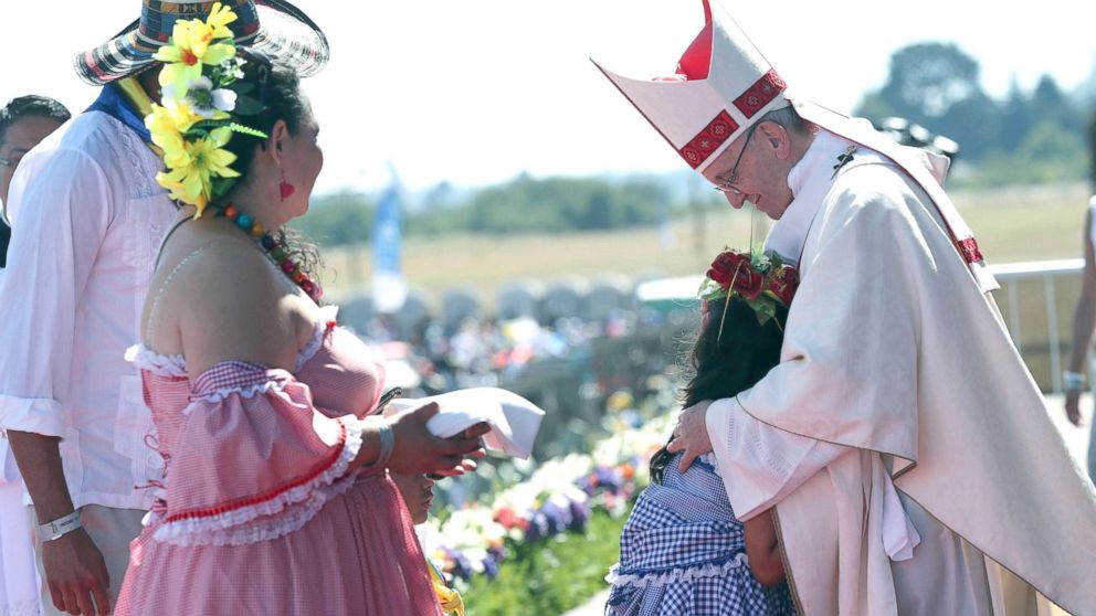 A child embraces Pope Francis in the offertory during a Mass at the Maquehue Air Base, in Temuco, Chile, Jan. 17, 2018. Francis is paying homage to Chileans who were tortured or killed at the air base. 