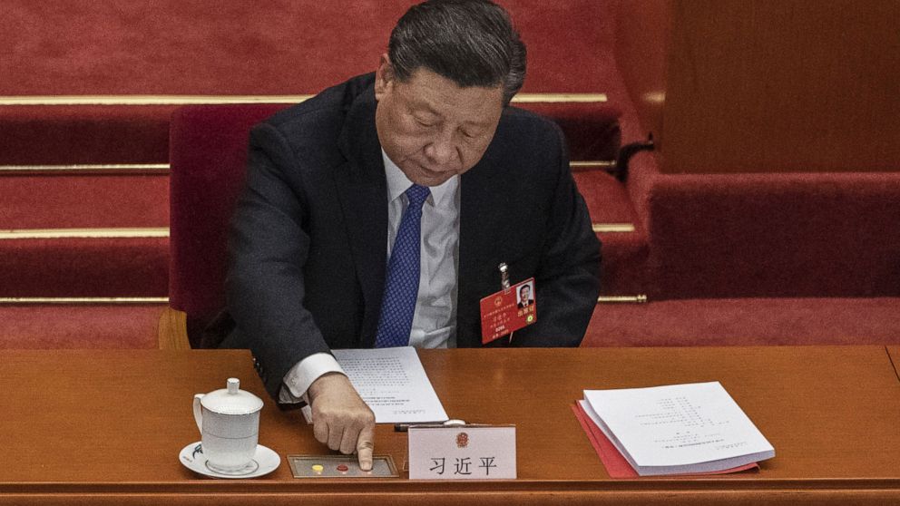 PHOTO: BEIJING, CHINA - MAY 28: Chinese president Xi Jinping, presses the green button as he votes on a new draft security bill for Hong Kong during the closing session of the National People's Congress on May 28, 2020 in Beijing.