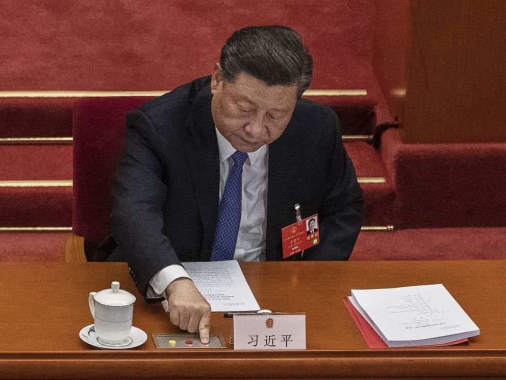 PHOTO: BEIJING, CHINA - MAY 28: Chinese president Xi Jinping, presses the green button as he votes on a new draft security bill for Hong Kong during the closing session of the National People's Congress on May 28, 2020 in Beijing.