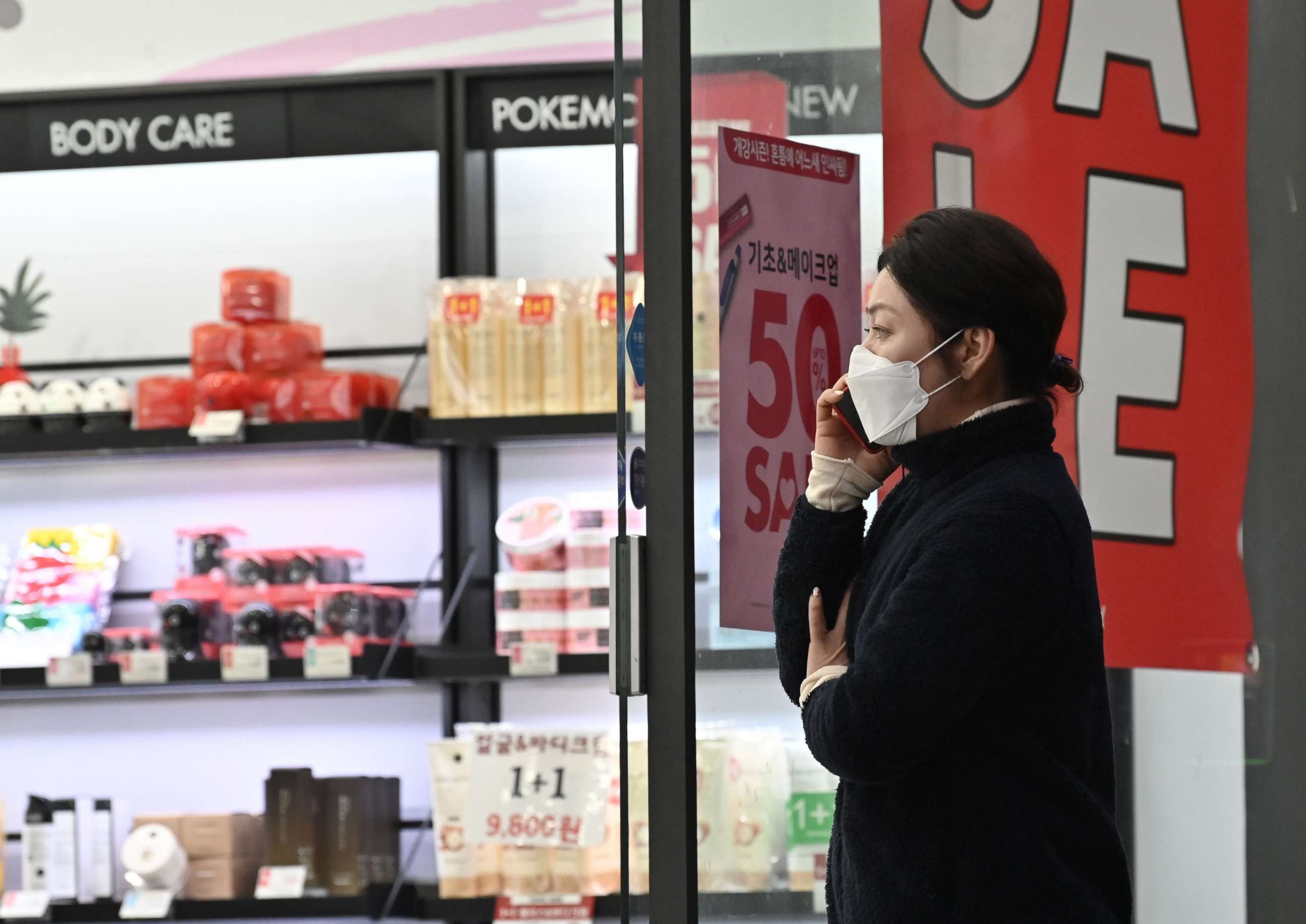 PHOTO: A woman wearing a face mask walks into a shop at Dongseongro shopping district in the southeastern city of Daegu on February 24, 2020. 