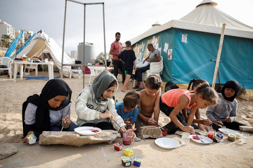 PHOTO: Displaced children paint on a beach next to a temporary shelter in Beirut, Lebanon, on Oct. 16, 2024.