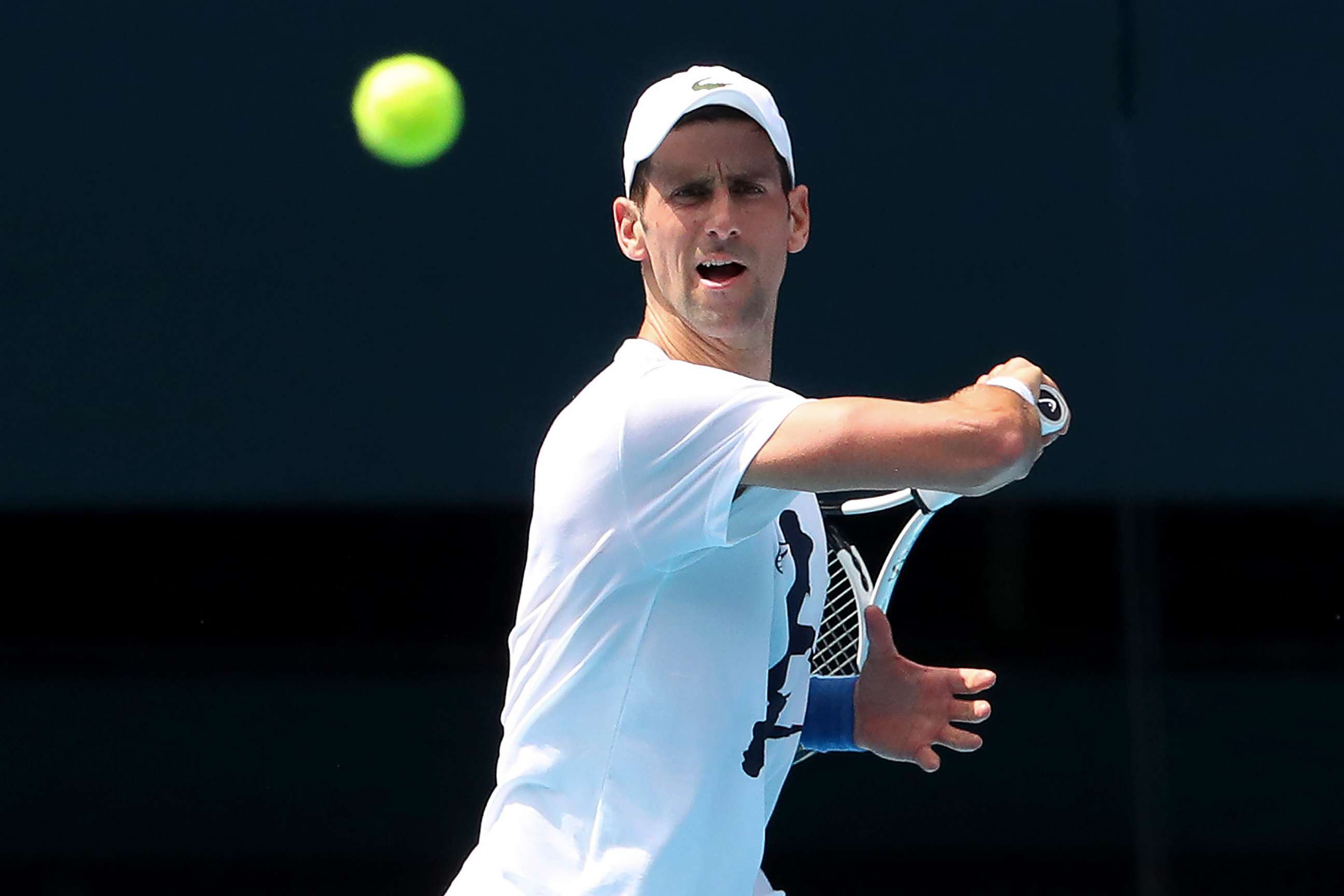 PHOTO: Defending champion Serbia's Novak Djokovic attends a practice session in the Rod Laver Arena ahead of the Australian Open at Melbourne Park in Melbourne, Australia, Jan. 11, 2022. 
