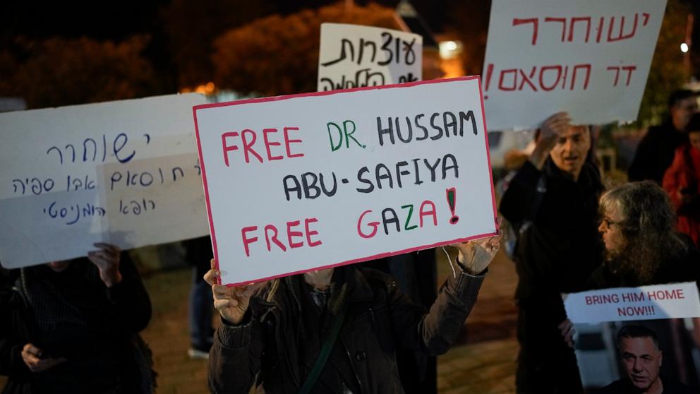 PHOTO: A woman holds a sign that reads "Free Dr. Hussam Abu Safiya, Free Gaza" during a protest in front of the Shin Bet offices in Tel Aviv, Israel, on Jan. 1, 2025.