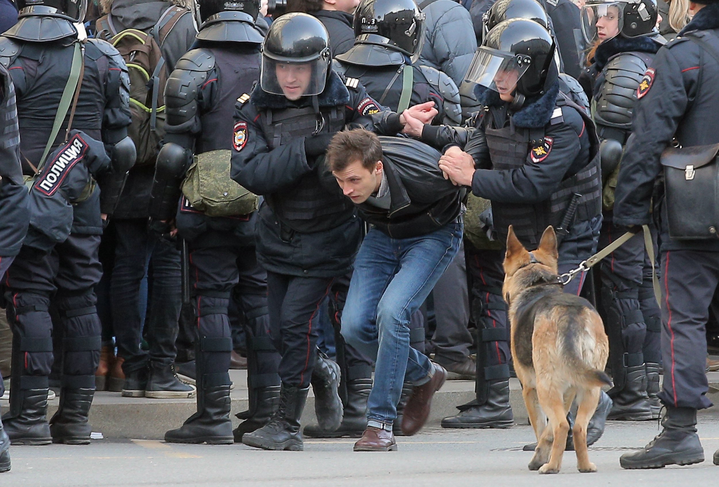 PHOTO: Russian riot policemen detain a demonstrator during an opposition rally in central Moscow, on March 26, 2017.