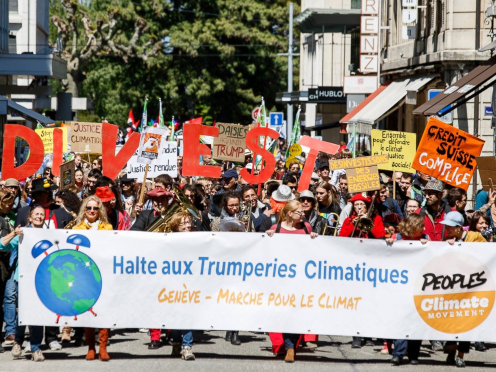 PHOTO: About five hundred protesters hold placards reading, Stop climactic Trumperies during the World Climate March in Geneva, Switzerland, April 29, 2017.