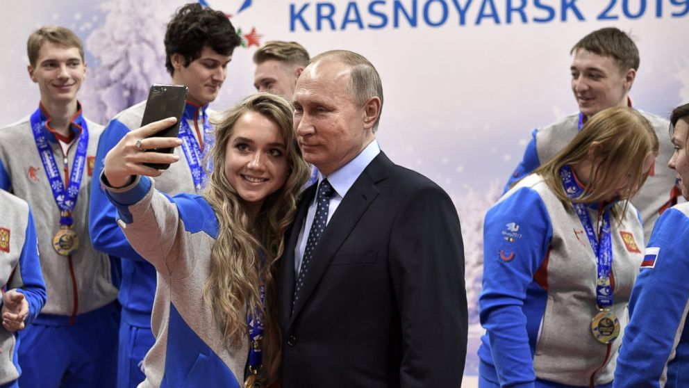 A woman takes a selfie with Russian President Vladimir Putin during his meeting with 2017 World Winter Universiade winners at the Biathlon Academy regional centre in Krasnoyarsk, Russia, March 1, 2017. 