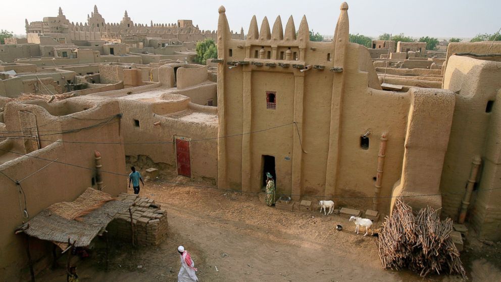 PHOTO: People walk the alleyways between mud-brick buildings in the ancient town of Djenne, Mali in this April 29, 2007 file photo.