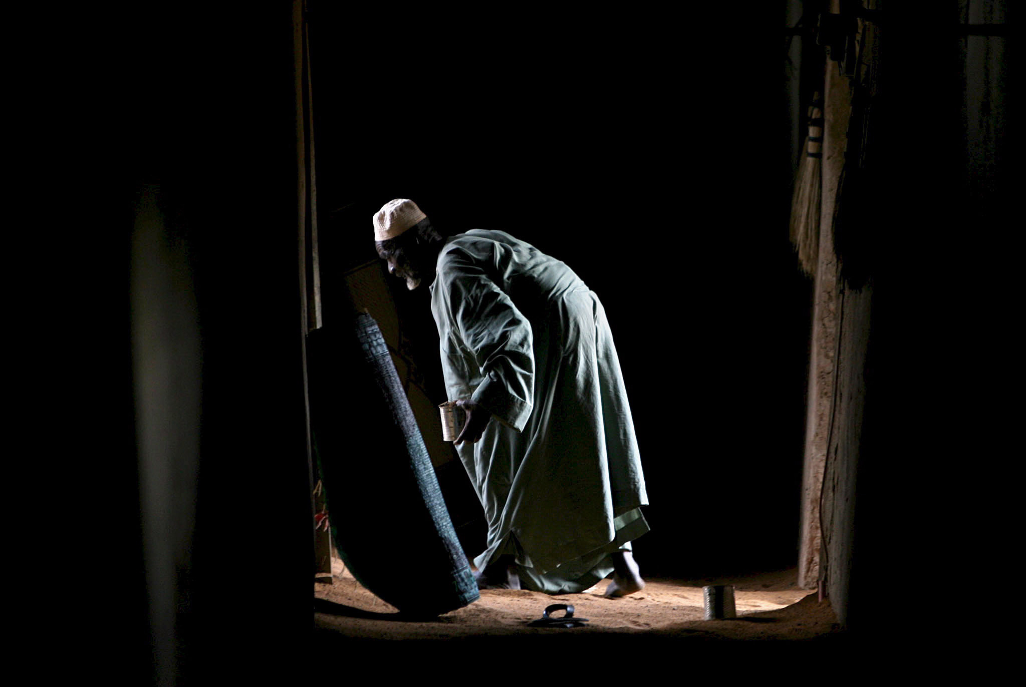 PHOTO: A man cleans inside the Grand Mosque, the largest mud-brick building in the ancient town of Djenne, one of the oldest cities in Mali in this, April 29, 2007, file photo.