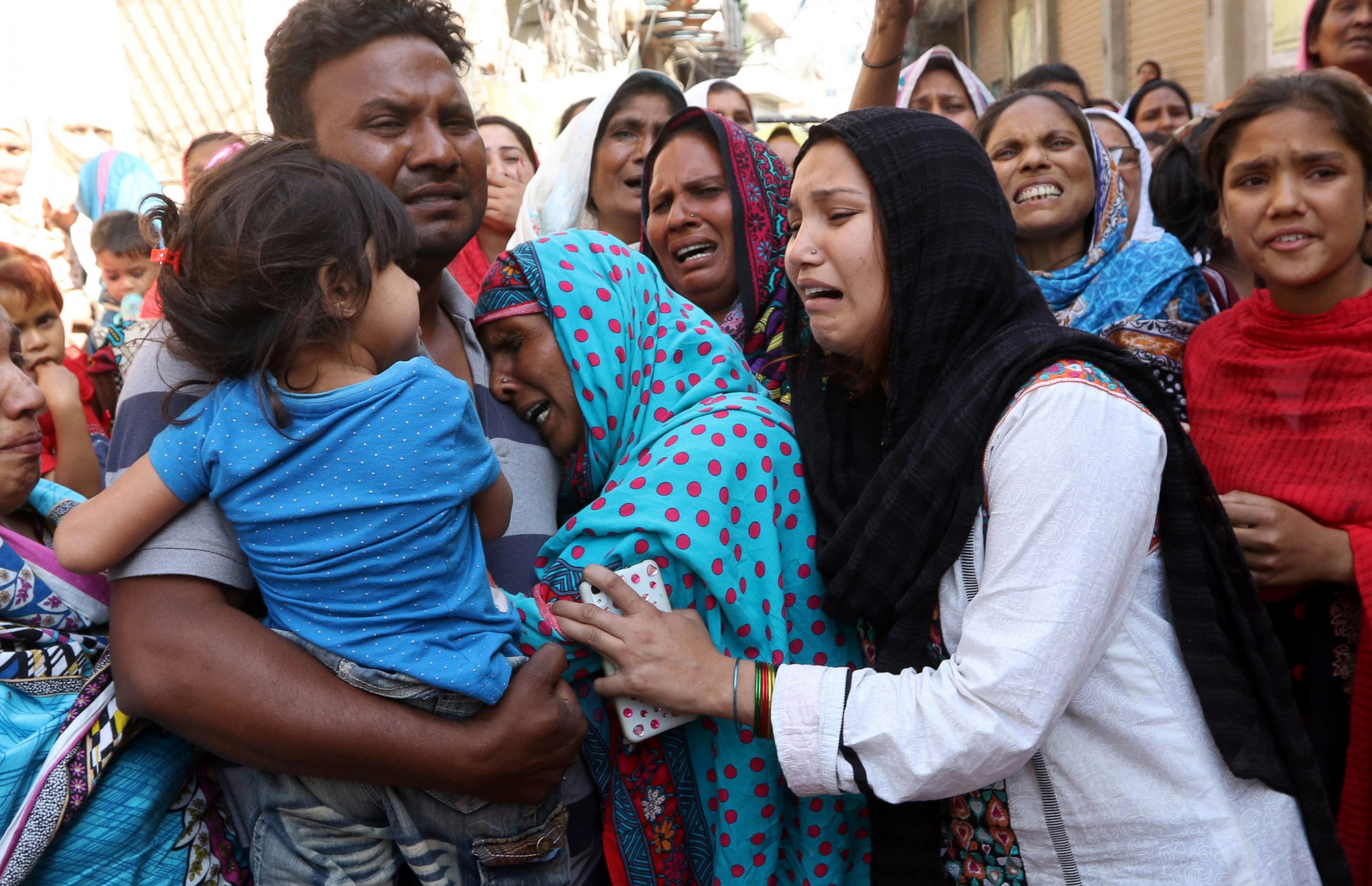 PHOTO: People cry during the funeral of their loved ones a day after a suicide bomb attack at a park on March 28, 2016, in Lahore, Pakistan.