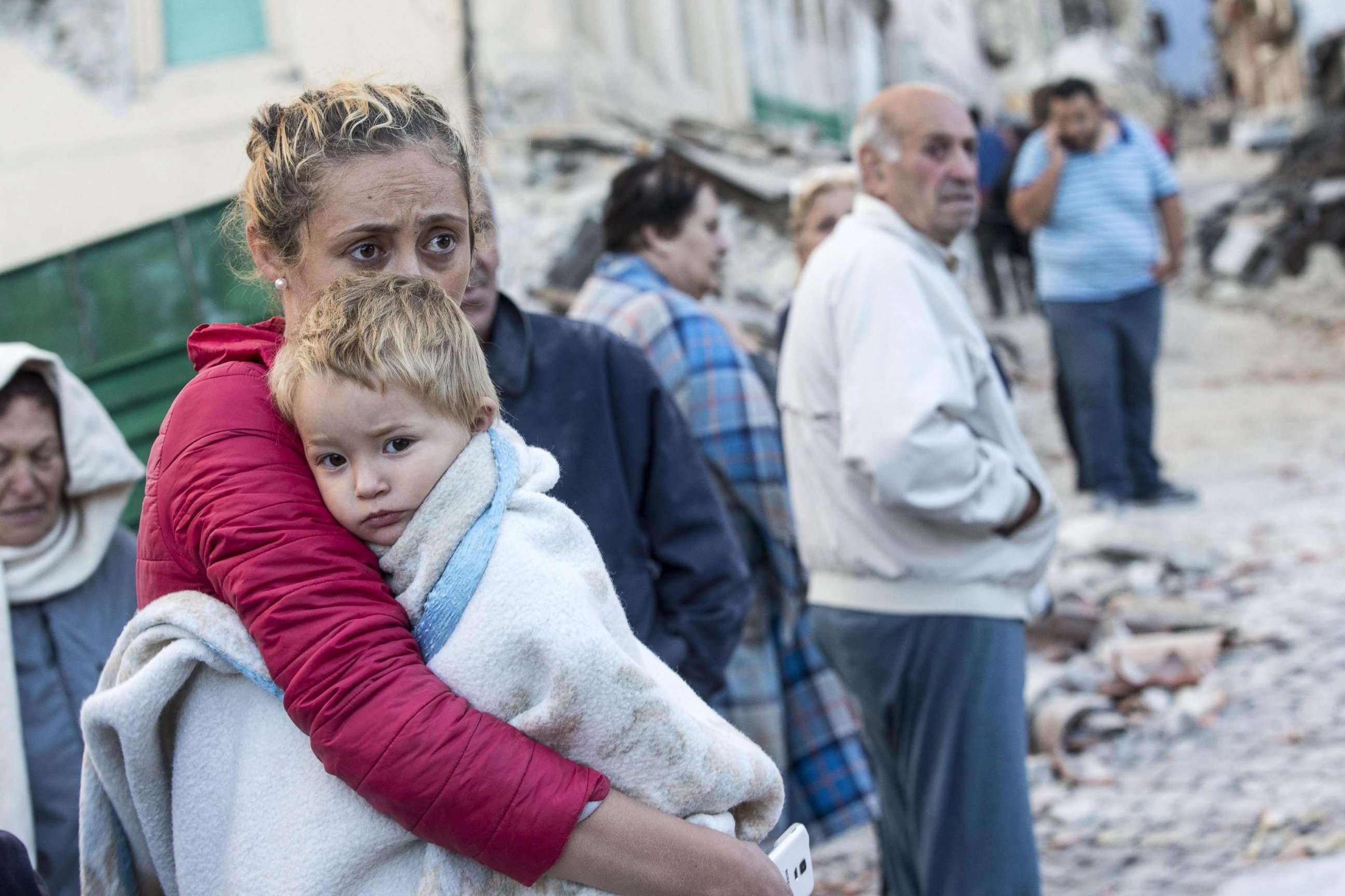 PHOTO: A mother embraces her son in Amatrice, Italy,  Aug. 24,  2016, following a earthquake.