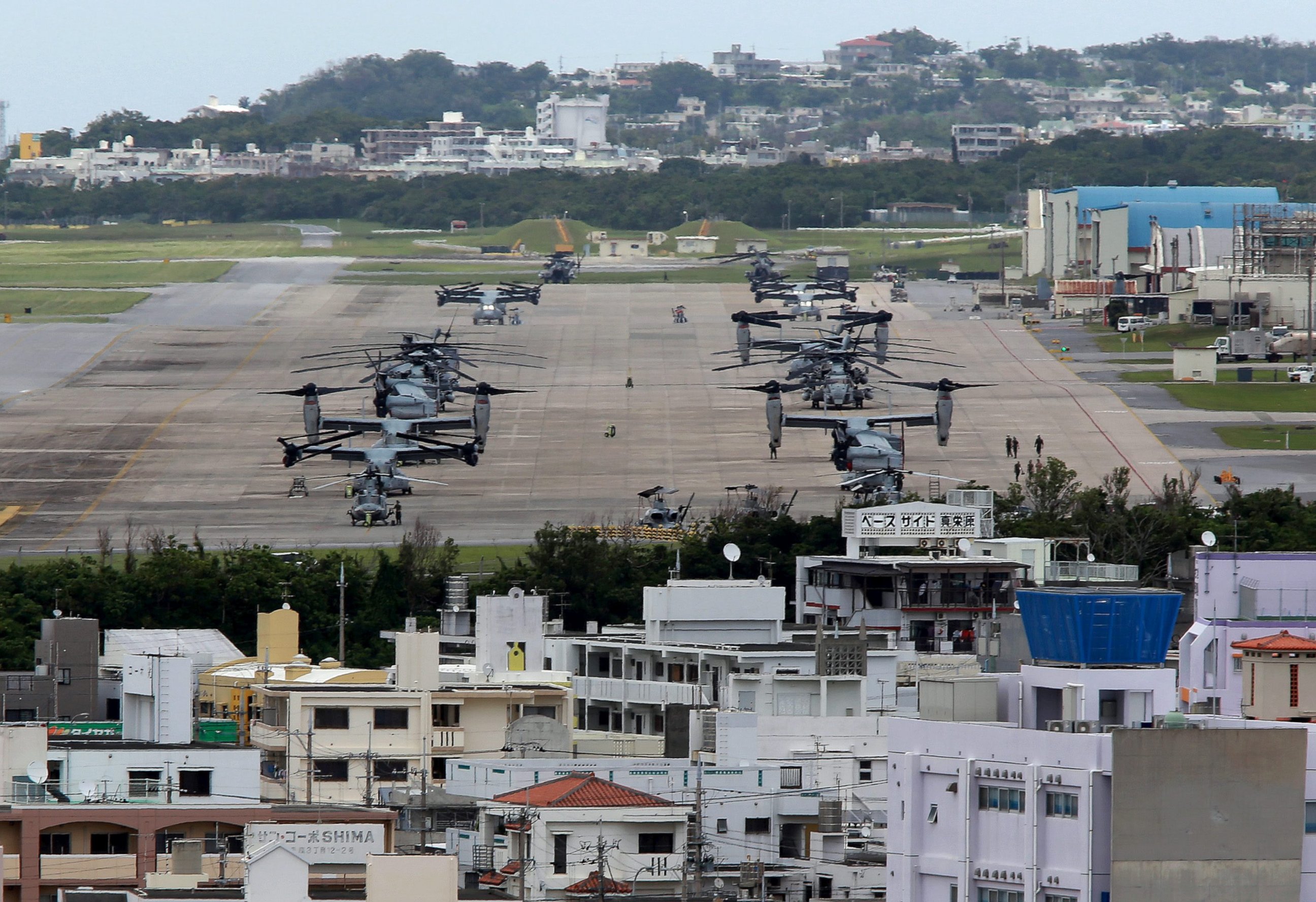 PHOTO: A file photo from May 19, 2015, shows US Marine Corps MV-22 Osprey aircrafts sitting on the tarmac at US Marine Corps Air Station Futenma surrounded by residential areas in Ginowan on Okinawa Island.