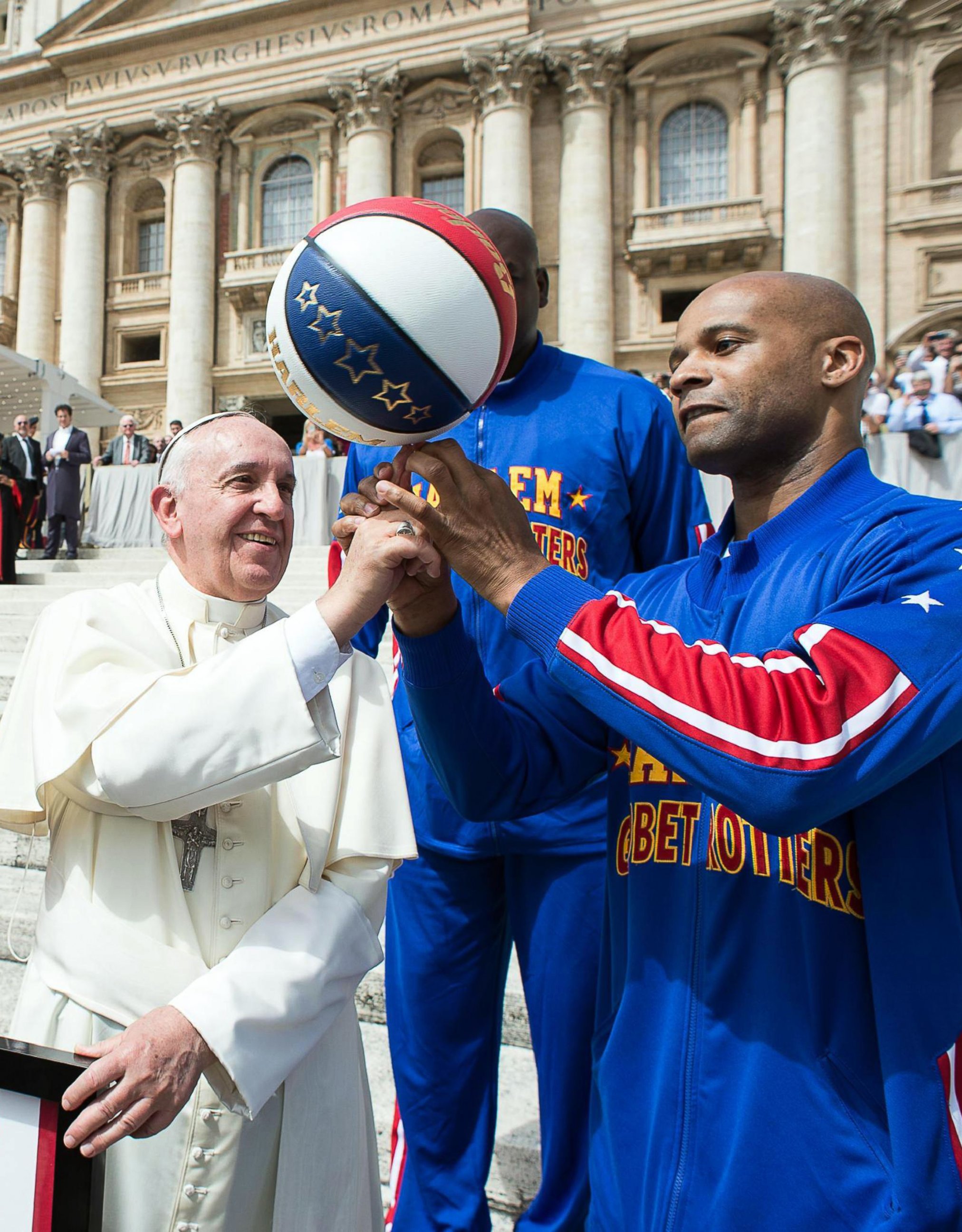 PHOTO: Harlem Globetrotters’ help Pope Francis spin the ball on his finger as they meet during the general audience in St. Peter's Square at the Vatican, May 6, 2015