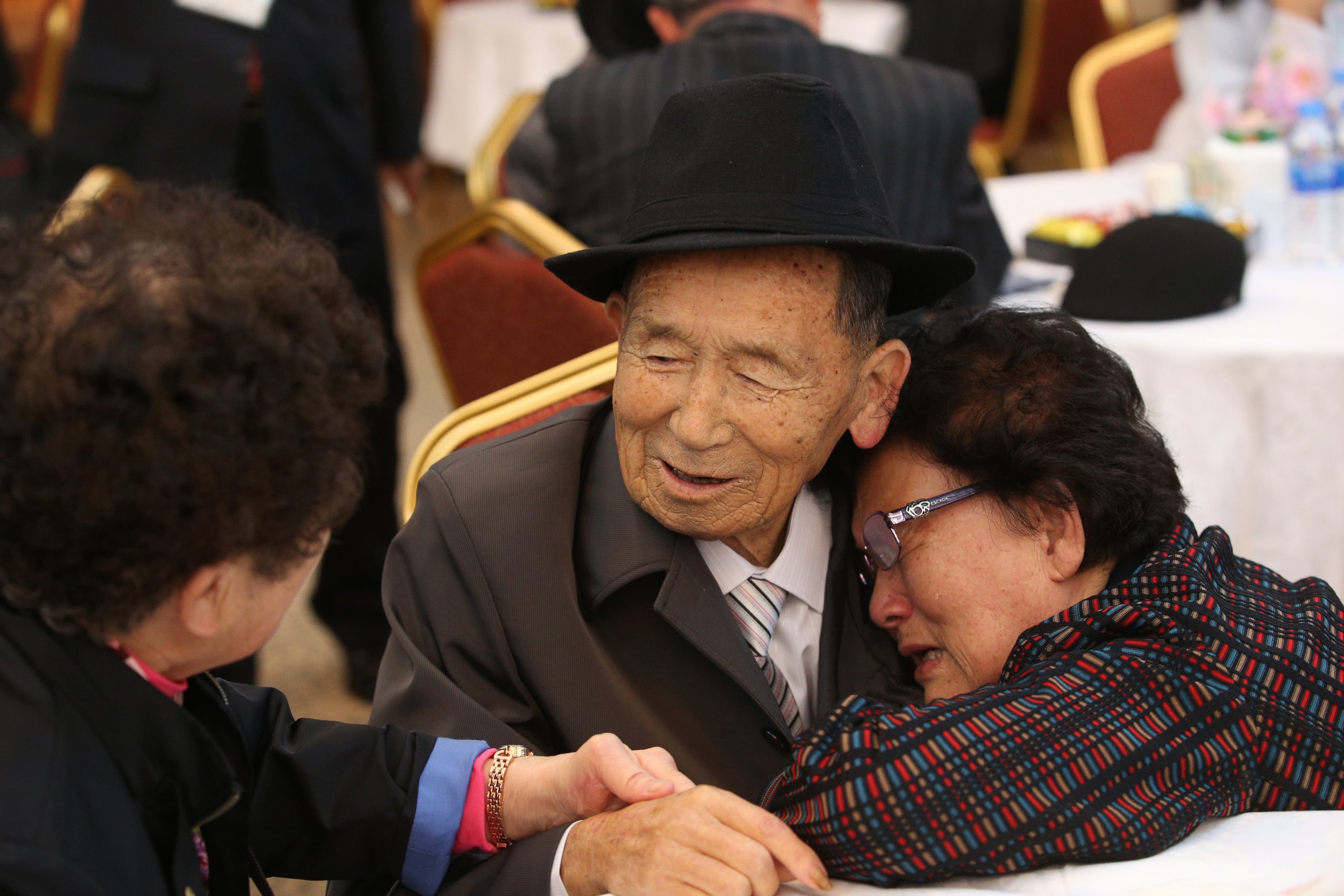 PHOTO: North Korean resident Kim Han-Sik, 86, center, meets his South Korean sister Kim Chul-Sik, 81, right, during a dinner on the first day of the reunions of separated families at Mount Kumgang resort, Kangwon Province, North Korea, Oct. 20, 2015. 