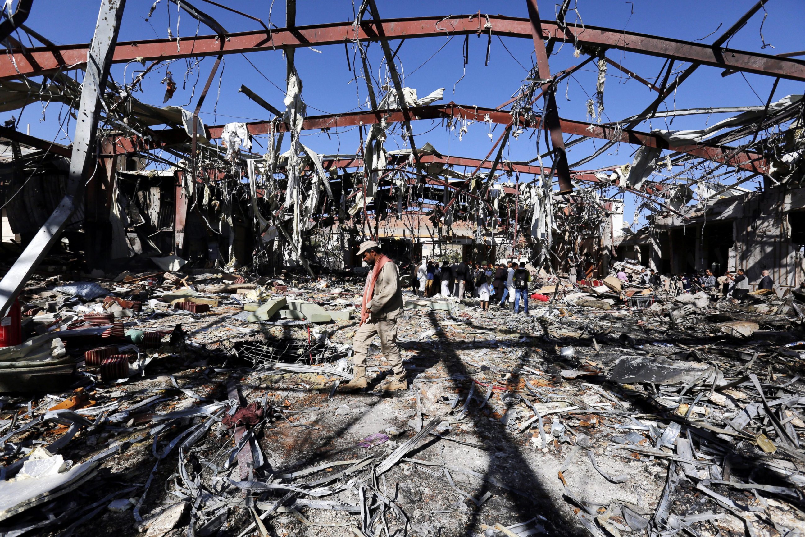 PHOTO: A militiaman patrols as Russian diplomats inspect the destroyed funeral hall, two days after an alleged Saudi-led airstrikes targeted it, in Sana'a, Yemen, Oct. 10, 2016.