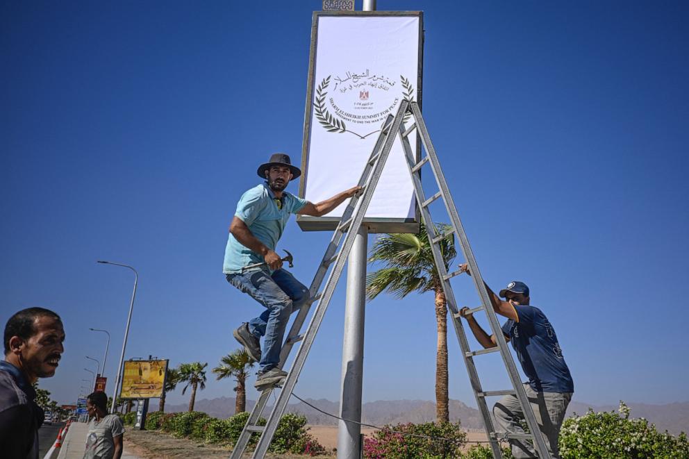 PHOTO: Municipal workers hang a sign near the airport in Sharm el-Sheikh, as the Egyptian Red Sea resort prepares to host a US-brokered international Gaza peace summit, on Oct. 12, 2025.