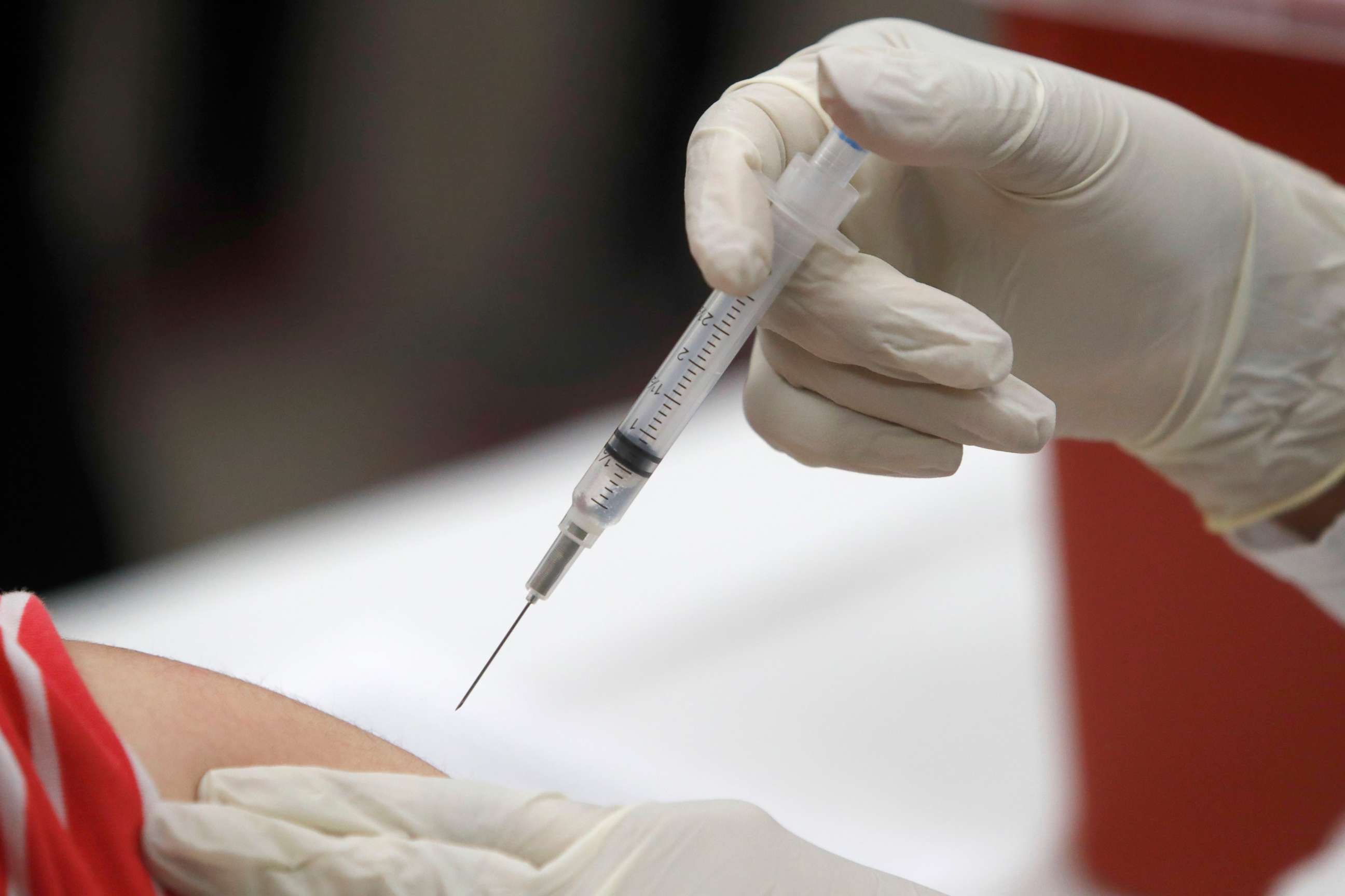 PHOTO: FILE - This Jan. 23, 2020 file photo shows a patient receiving a flu vaccination in Mesquite, Texas. On Feb. 20, 2020, the Centers for Disease Control and Prevention said the vaccine has been more than 50% effective in preventing flu illness