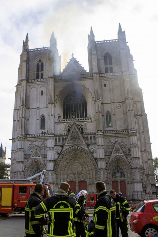 PHOTO: Fire fighters take a break after extinguish the blaze at the Gothic St. Peter and St. Paul Cathedral, in Nantes, western France, Saturday, July 18, 2020. T
