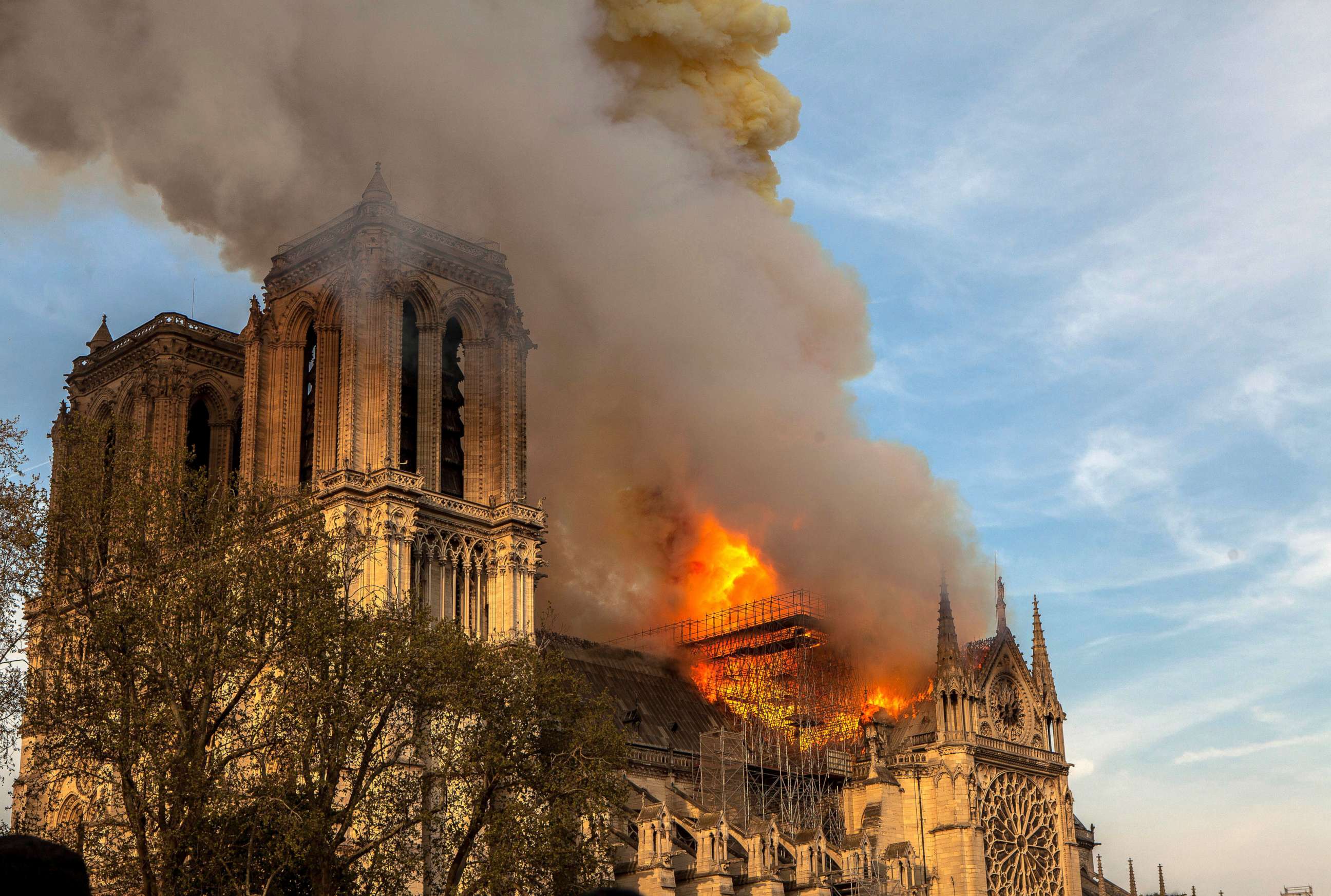 PHOTO: FILE - In this April 15, 2019, file photo, the Notre Dame Cathedral burns in Paris. The cathedral stands crippled, locked in a dangerous web of twisted metal scaffolding one year after a cataclysmic fire.