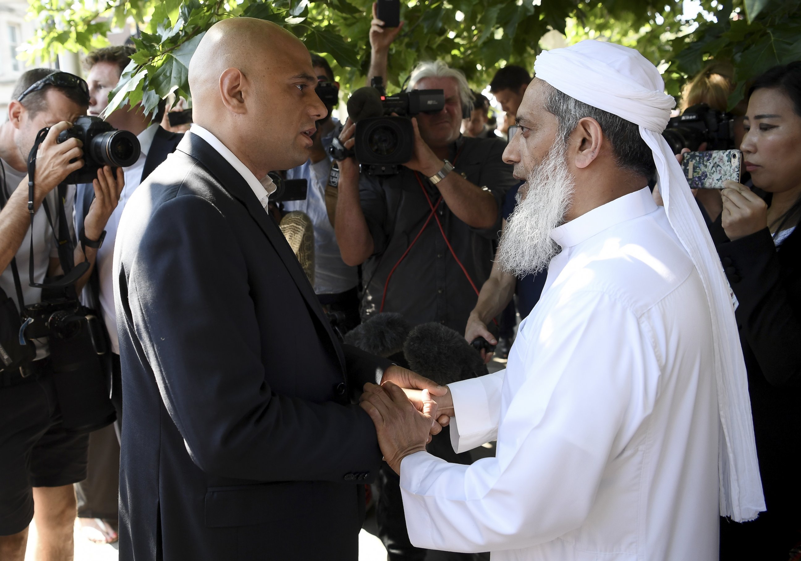 PHOTO: Secretary of State for Communities and Local Government Sajid Javid (L) speaks to an Imam at the scene of a terror attack in Finsbury Park, June 19, 2017, in London.