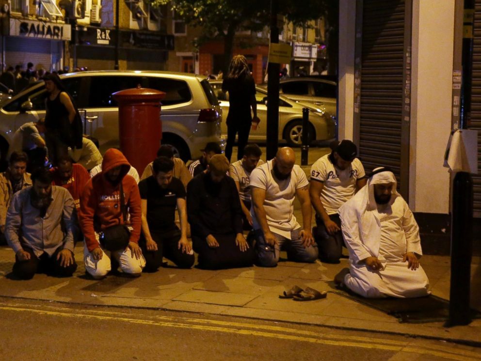 PHOTO: Muslims pray on a sidewalk in the Finsbury Park area of north London after a vehicle hit pedestrians, on June 19, 2017. 