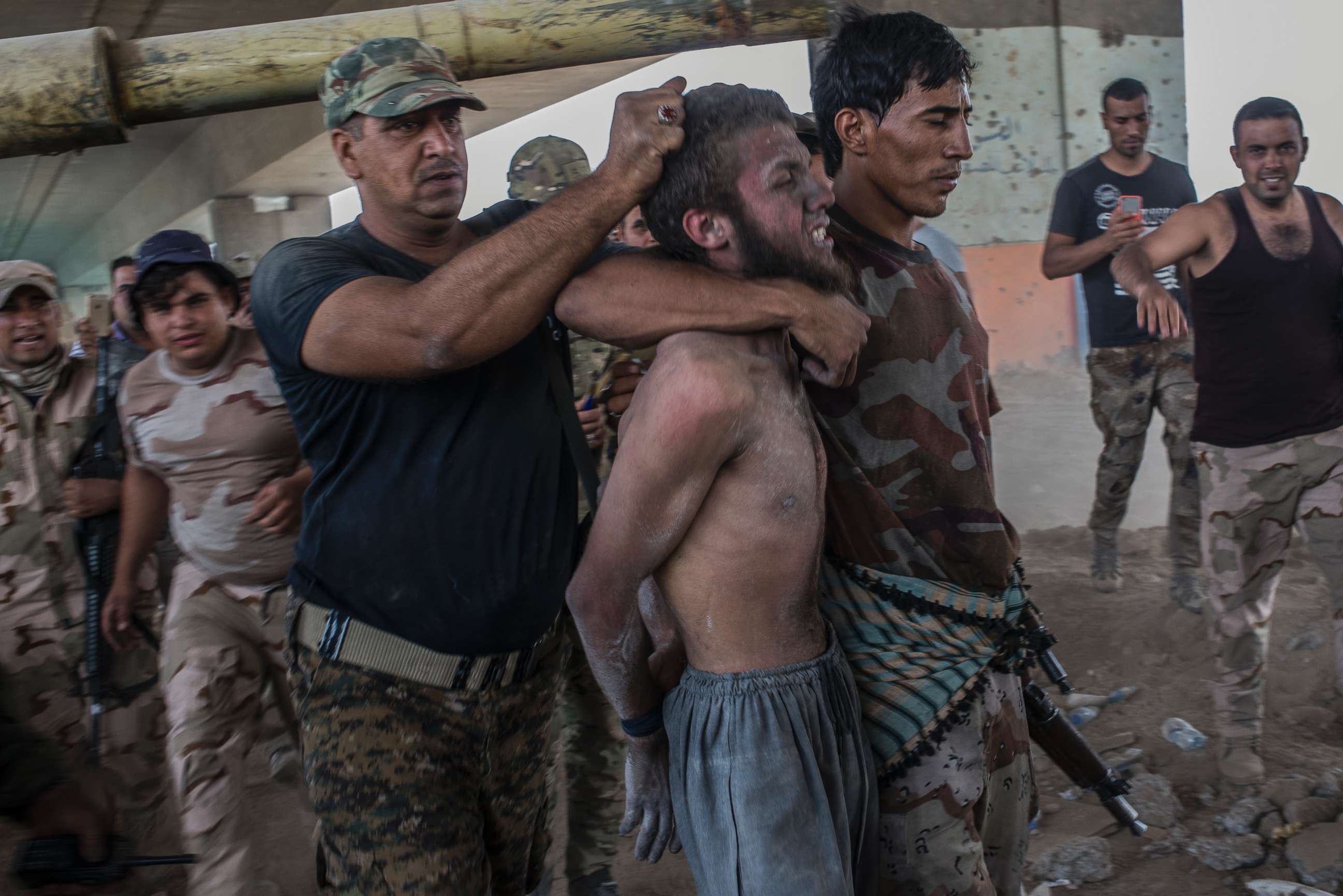 PHOTO: A man suspected of being an Islamic State militant is detained by the Iraqi Army on July 10, 2017 in Mosul, Iraq. Iraqi forces have declared victory but fighting continues as forces face fierce resistance from the desperate remaining IS militants.