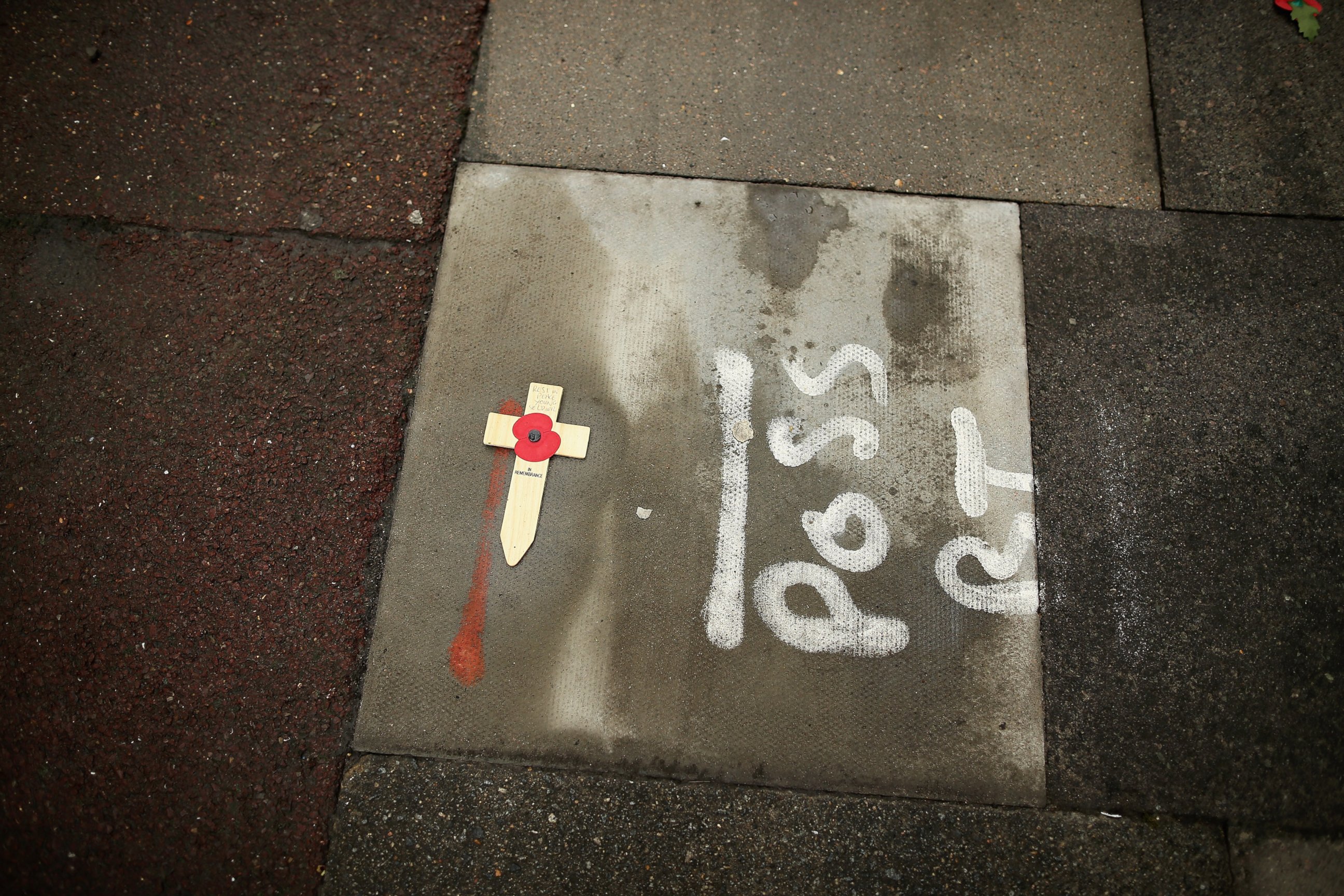 PHOTO: A single cross lies on the pavement at the scene where Lee Rigby, a soldier of the 2nd Battalion the Royal Regiment of Fusiliers, was killed on May 24, 2013 in London.