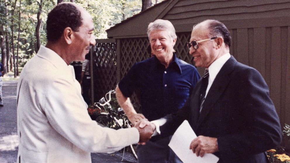 PHOTO: Egyptian President Anwar al-Sadat, left, shakes hands with Israeli Premier Menachem Begin, as President Jimmy Carter looks on September 6, 1978 at Camp David, the presidential retreat in Maryland.