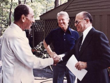 PHOTO: Egyptian President Anwar al-Sadat, left, shakes hands with Israeli Premier Menachem Begin, as President Jimmy Carter looks on September 6, 1978 at Camp David, the presidential retreat in Maryland.